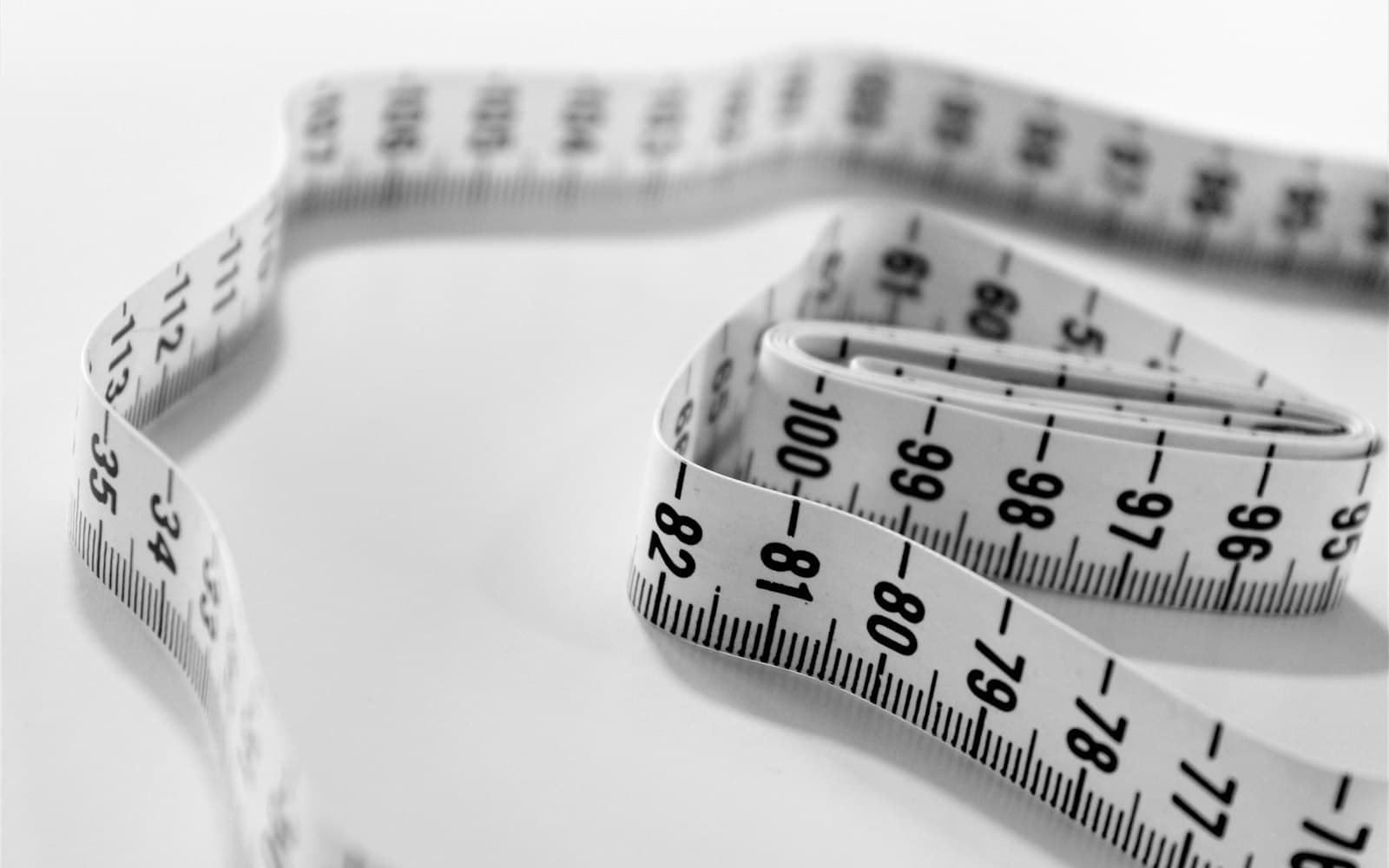 A white tape measure, coiled