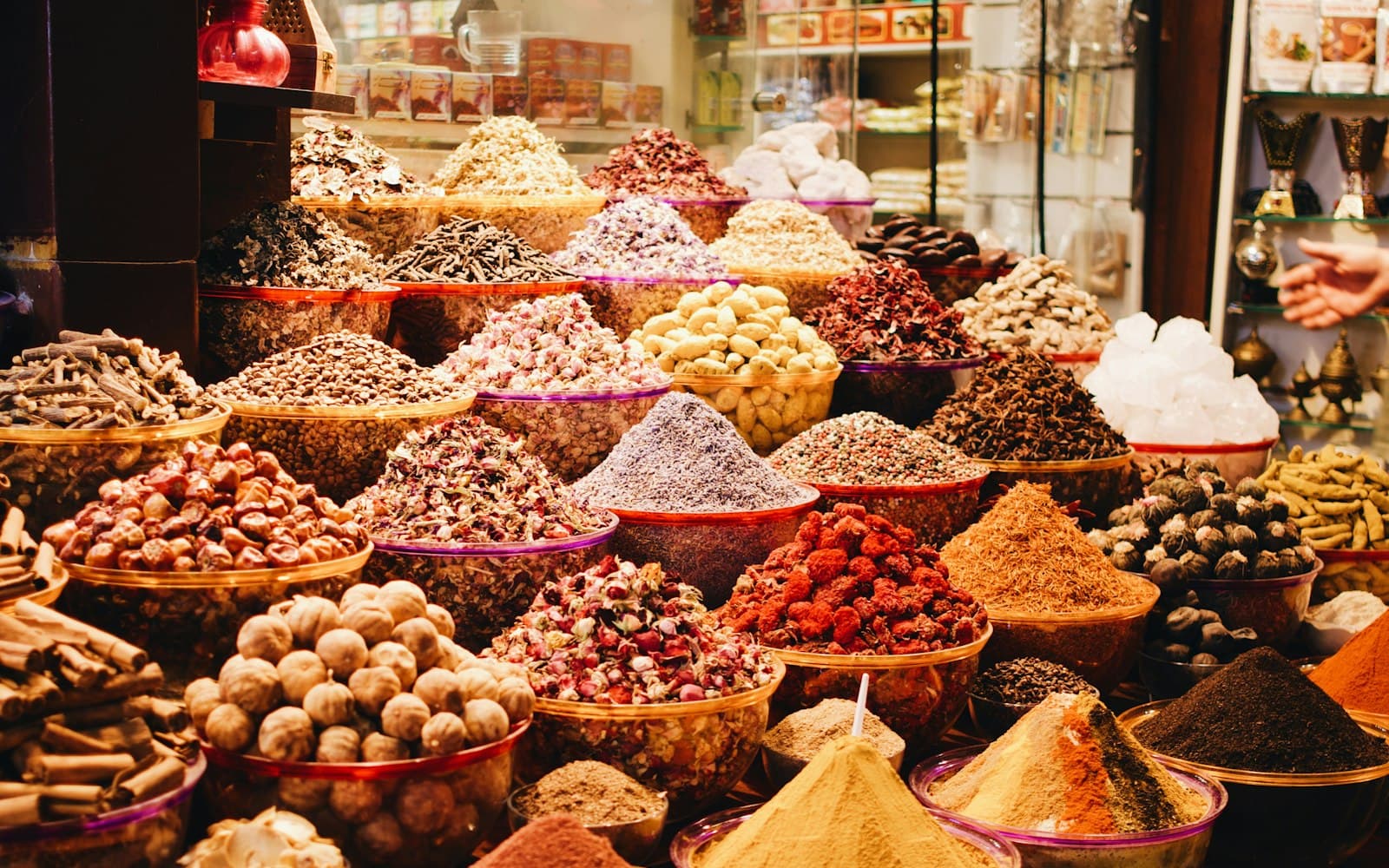 Heaps of spices, nuts and dried fruit on a market stall